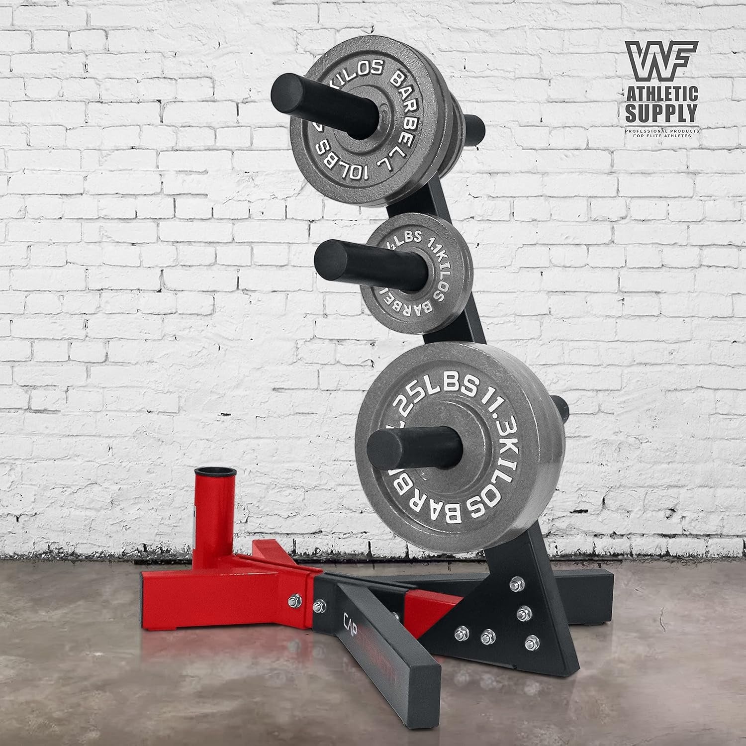 Barbell with weight plates on a stand against a white brick wall.