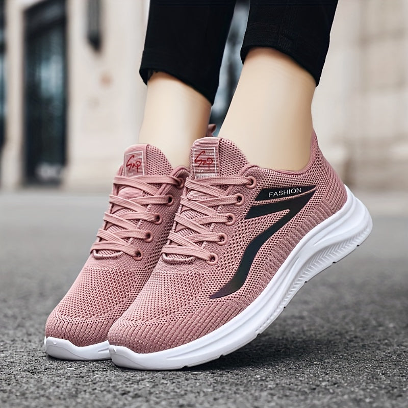 Pink running shoes with white soles worn by a person on a blurred street background