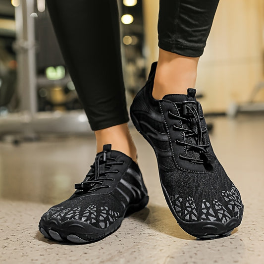 Black deadlift shoes with unique sole design worn indoors.