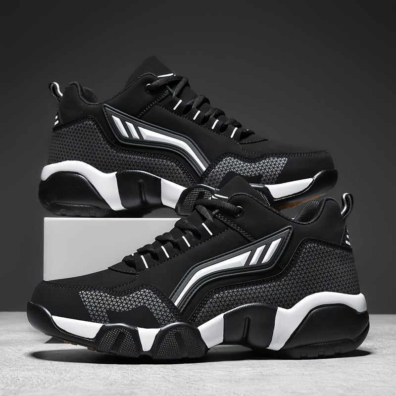 Black and white lace up sneakers stacked on a gray background