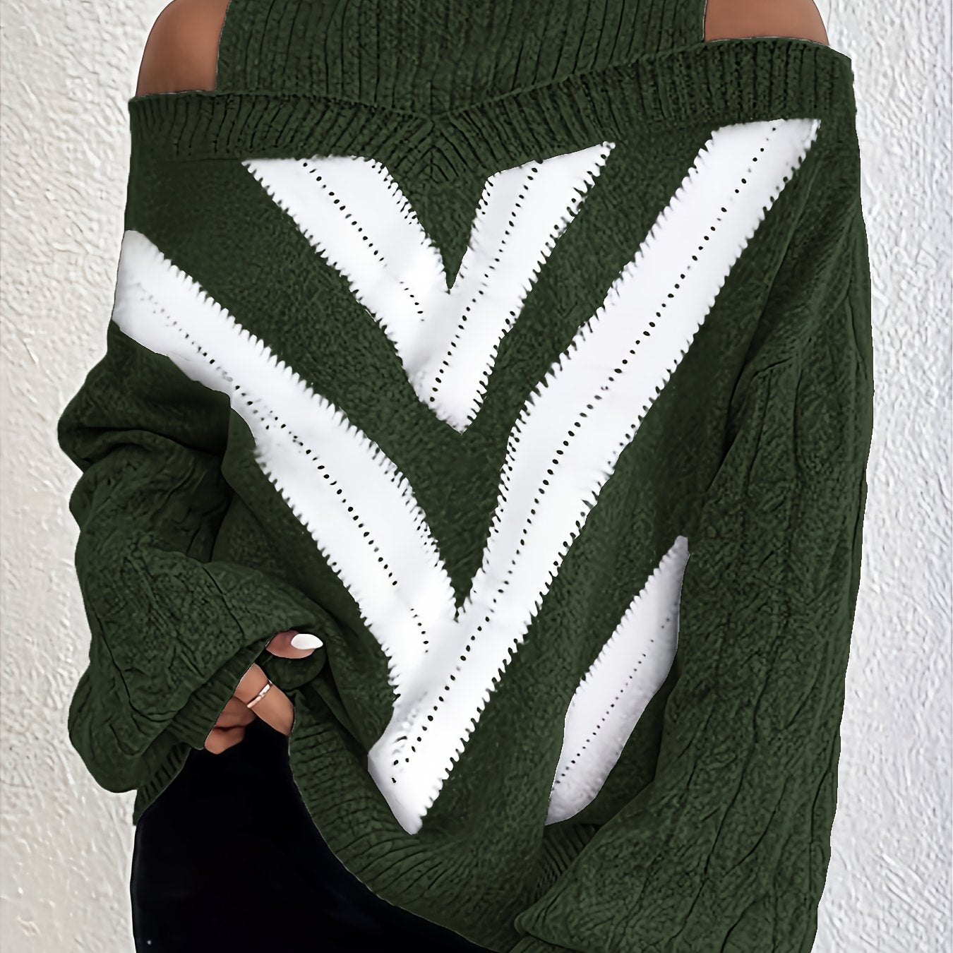 Green off the shoulder sweater with white V-shaped design on a plain background