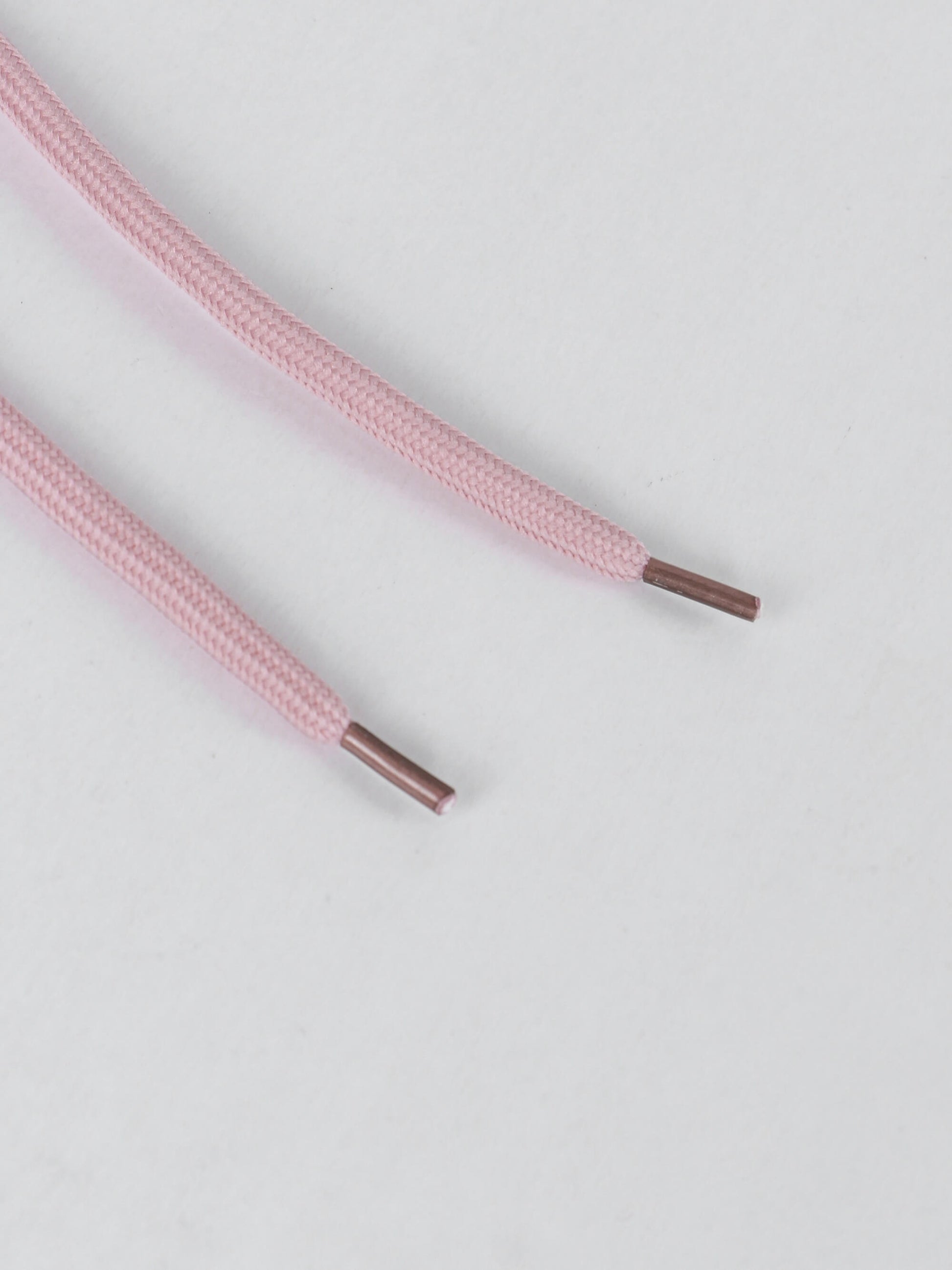 Pink women's lounge set laces with brown tips on a light gray background