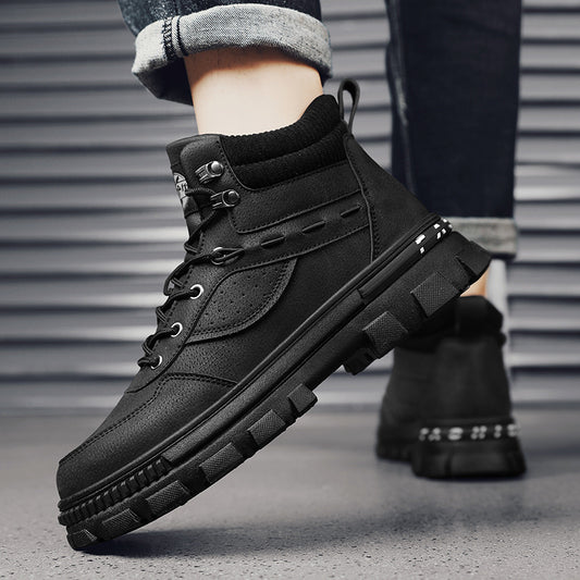 A person wearing a black Martin high top boots