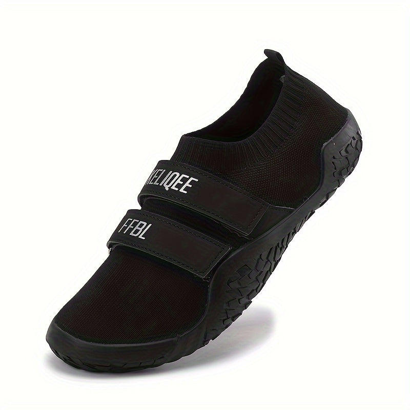 Black shoes for lifting weights with velcro straps on a white background