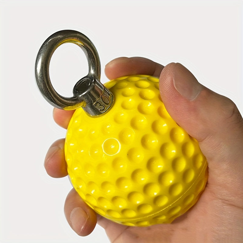 Yellow pull up grip ball with a metal ring held in a hand against a white background