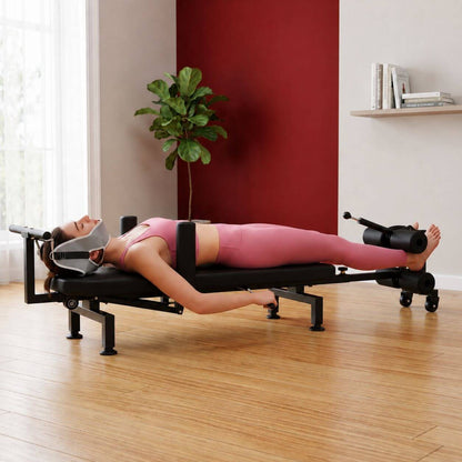 Woman using a Full Body Stretching Machine with Cervical Traction & Spinal Decompression in a home setting with a plant and books in the background