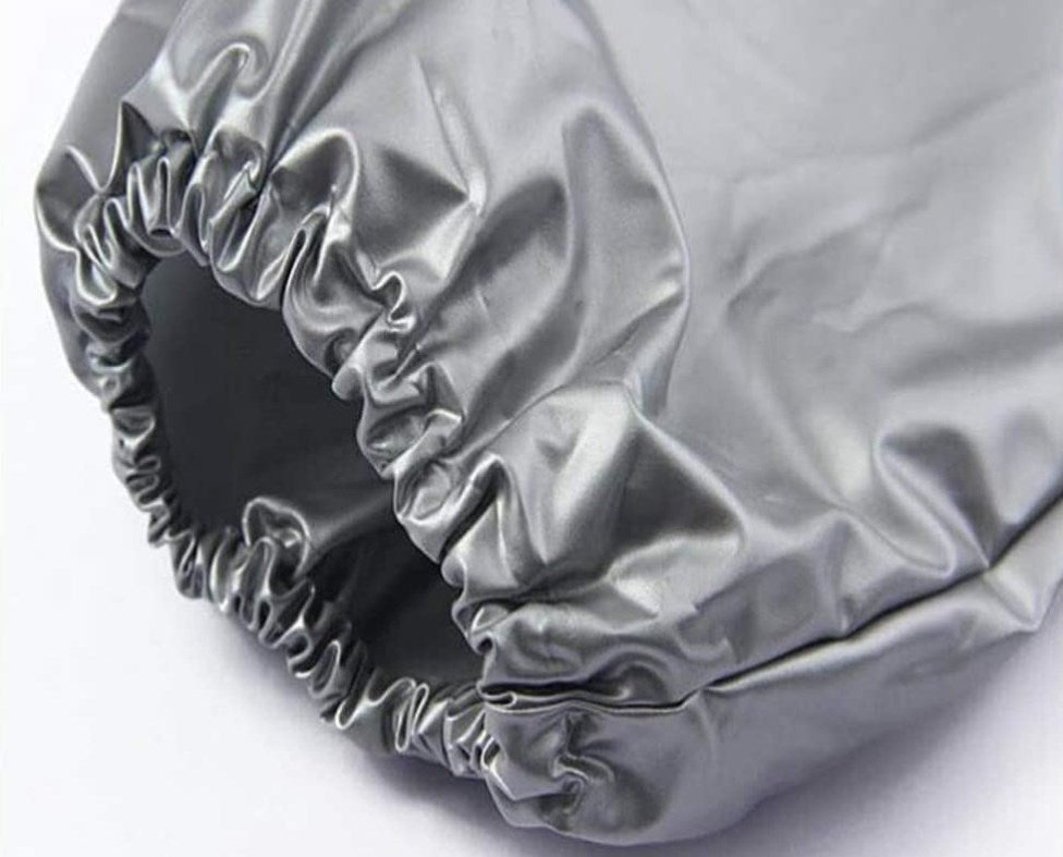 The sleeve of a silver sauna sweat suiton a white background