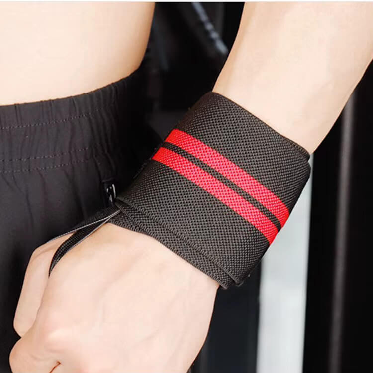Black wrist support with red stripes worn by a person