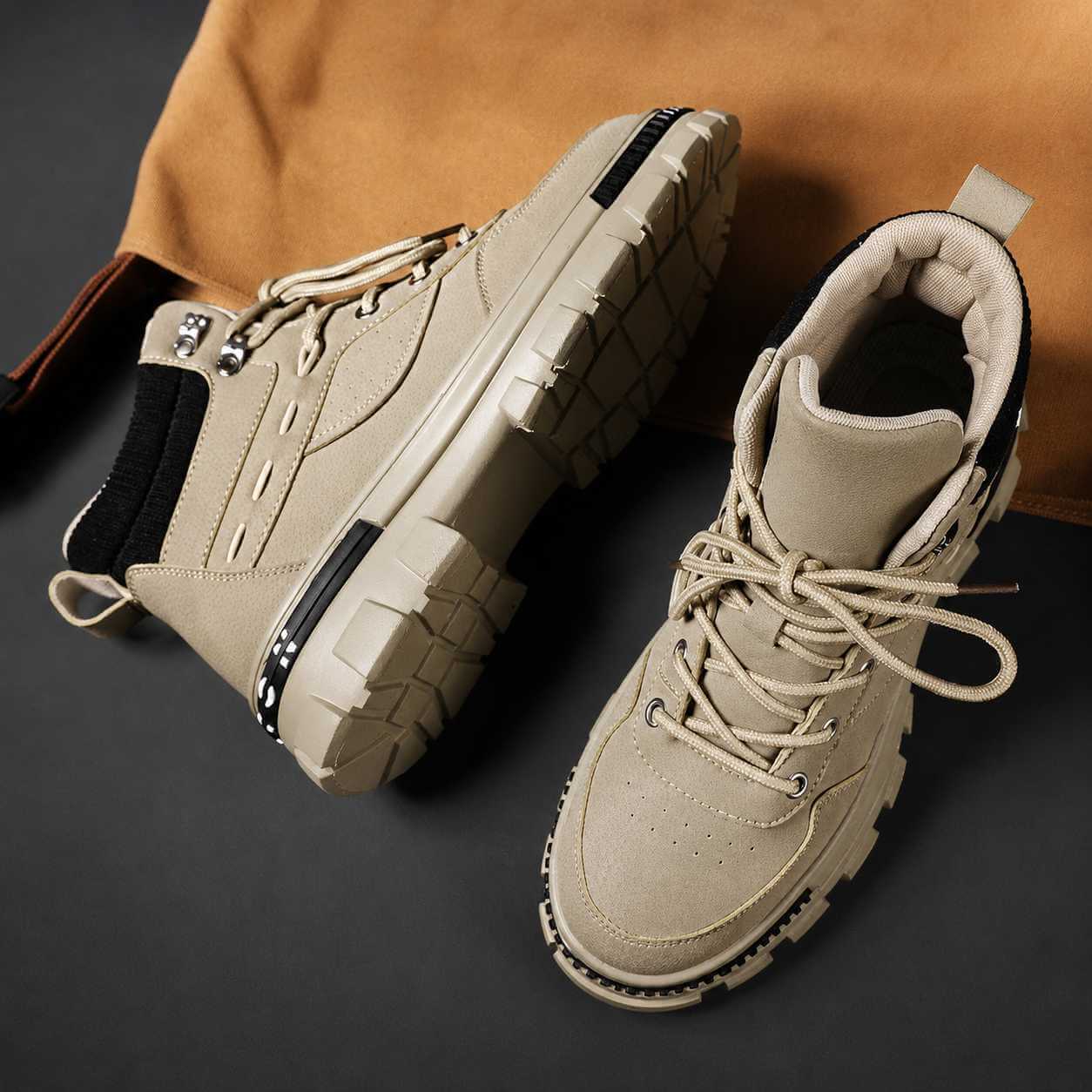 Beige Martin high top boots on a dark background