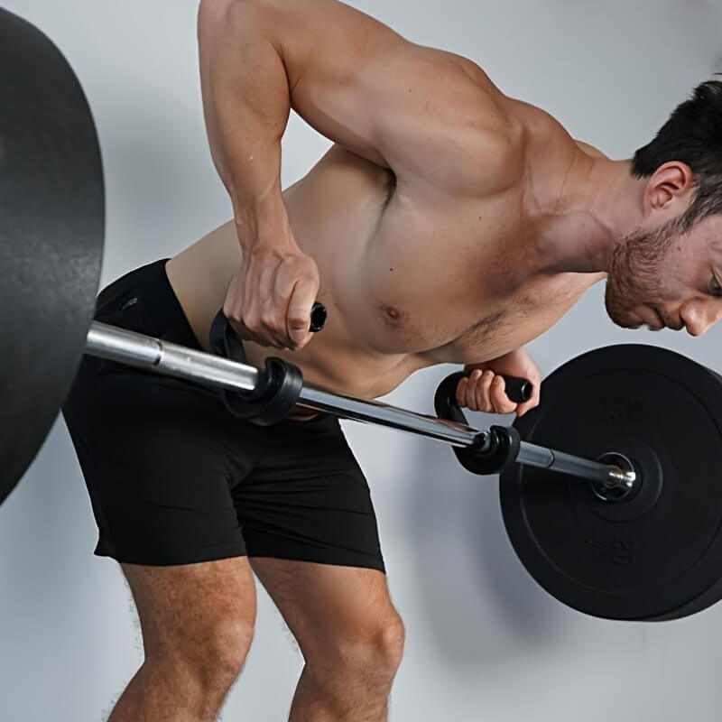 Man lifting a barbell with pull up grips