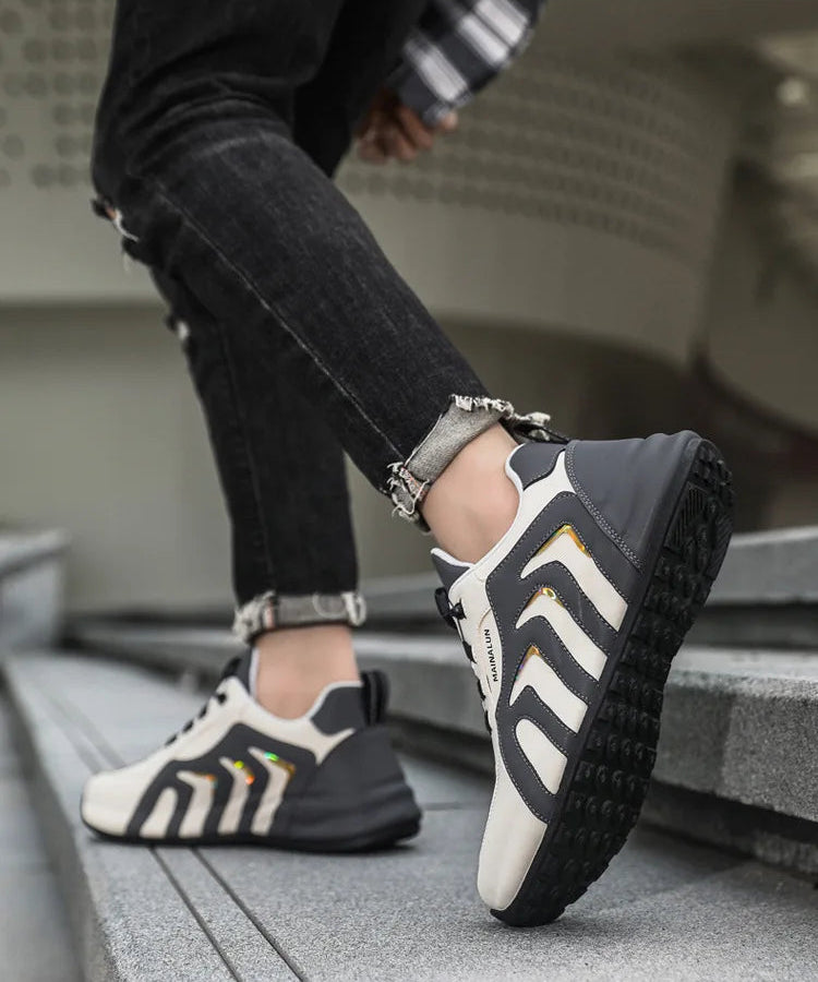 Person wearing black and white athletic shoes on a step.