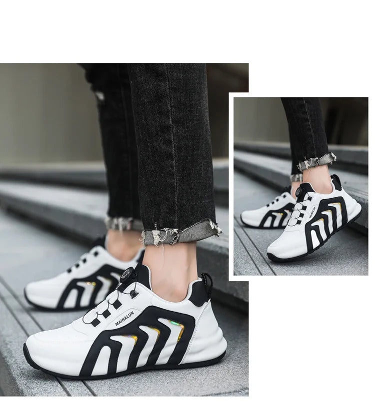 White sneakers with black and gold accents worn by a person on a concrete surface.