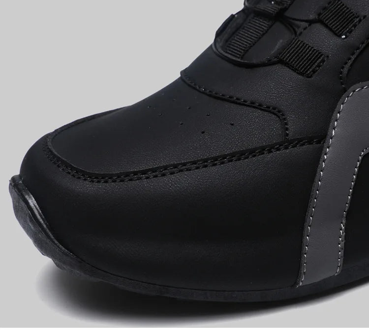 The front of a Black sneaker with on a gray background