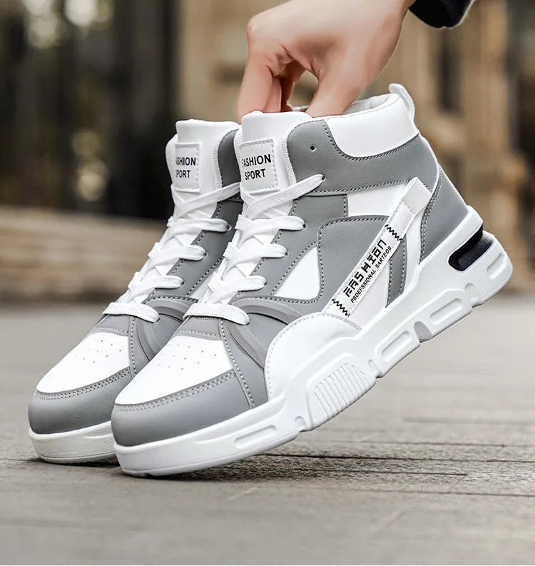 Gray and white sneakers being held on a blurred background