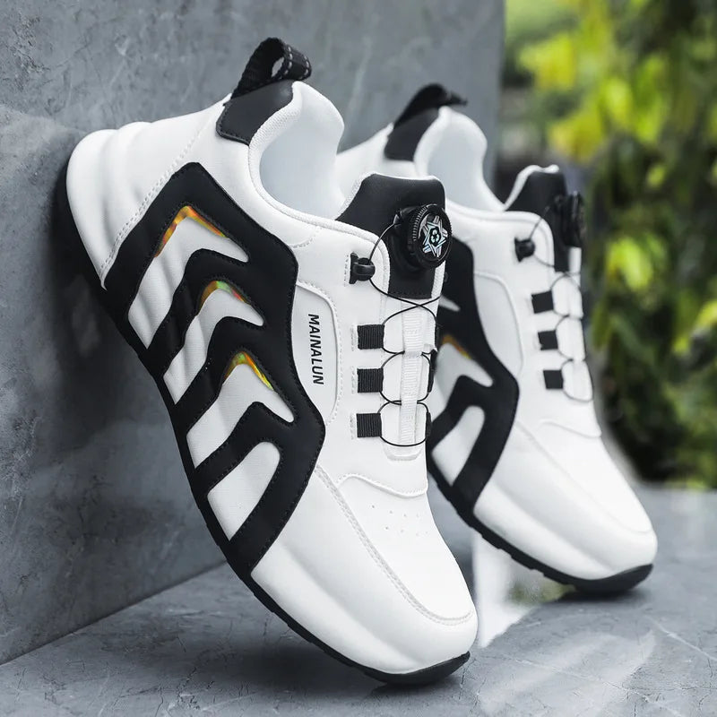White sneakers with black and orange accents on a gray surface
