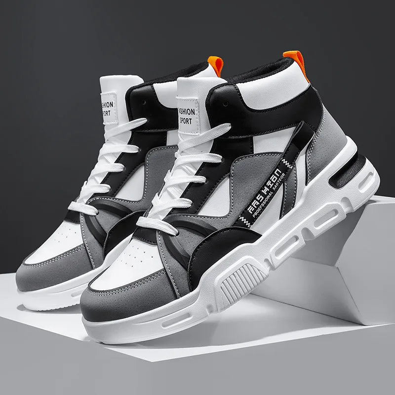 Black, white, and gray high-top sneakers on a gray background