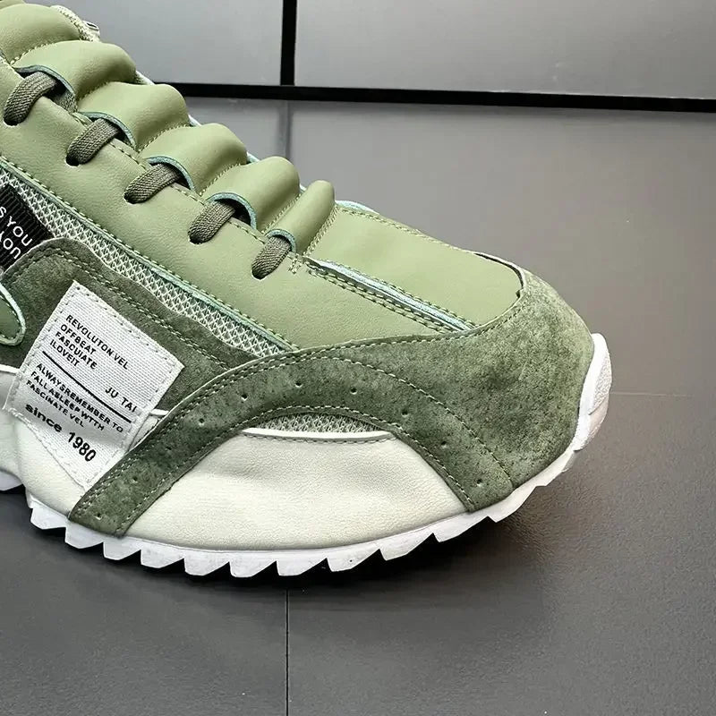 Green summer sneaker with a white sole on a gray background