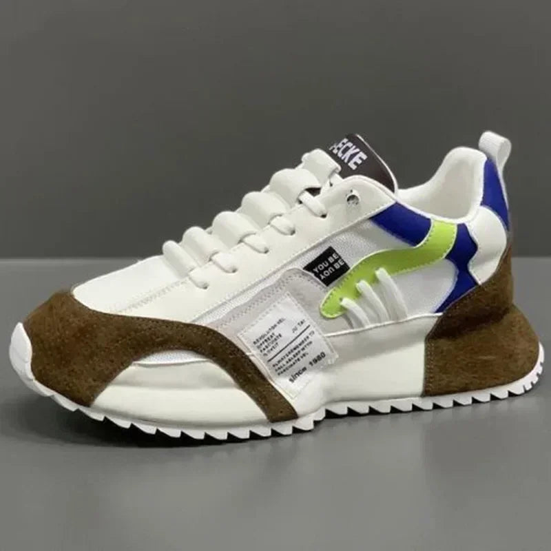 White summer sneaker with brown and blue accents on a gray background