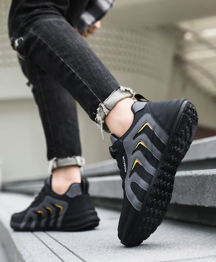Black and gray athletic shoes worn by a person on a concrete surface.