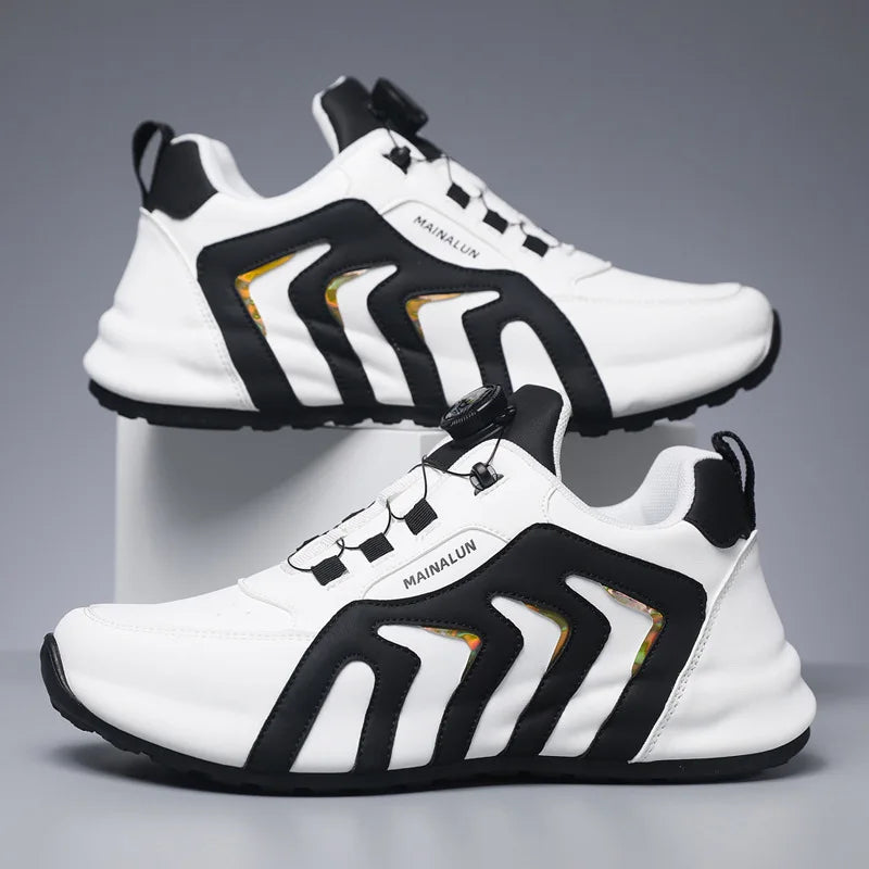 White and black athletic shoes with gold accents on a gray background