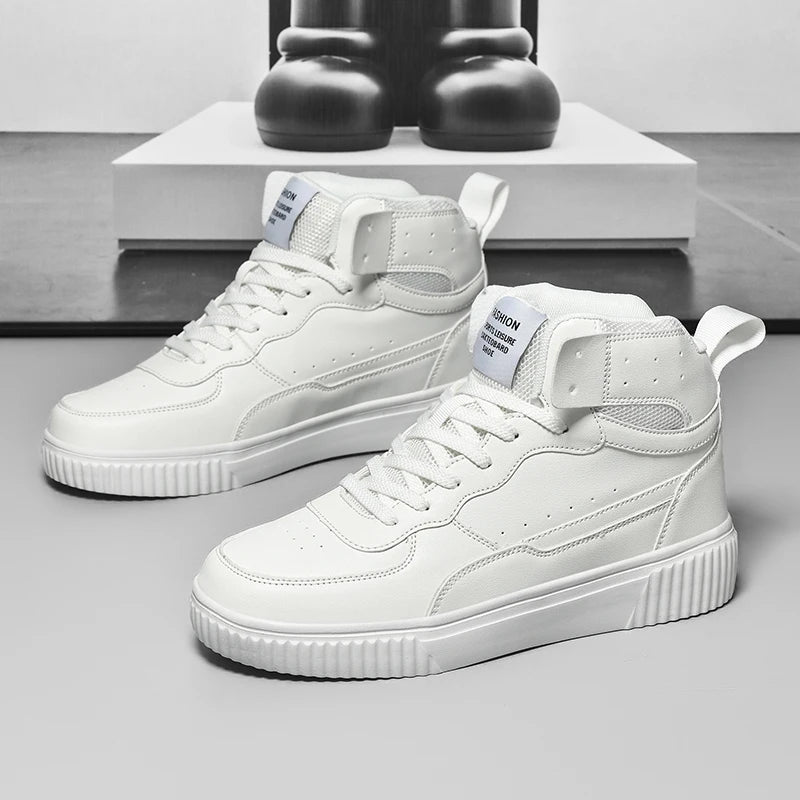 White high-top sneakers on a gray surface with a minimal background