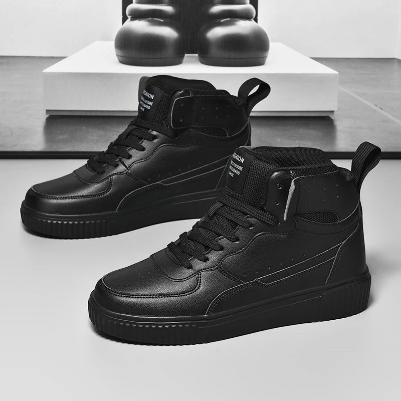 Black high-top sneakers on a light gray surface with a blurred background