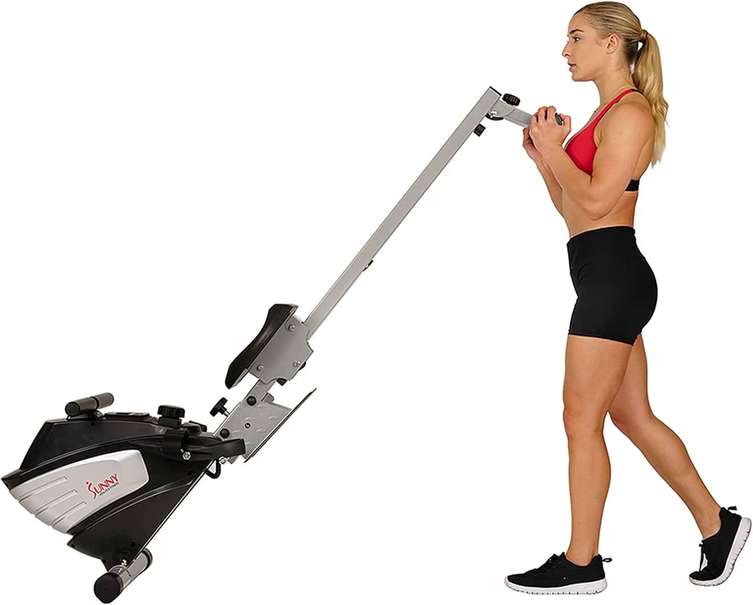 A woman working out with a sunny magnetic rowing machine sold by 100 Spartans