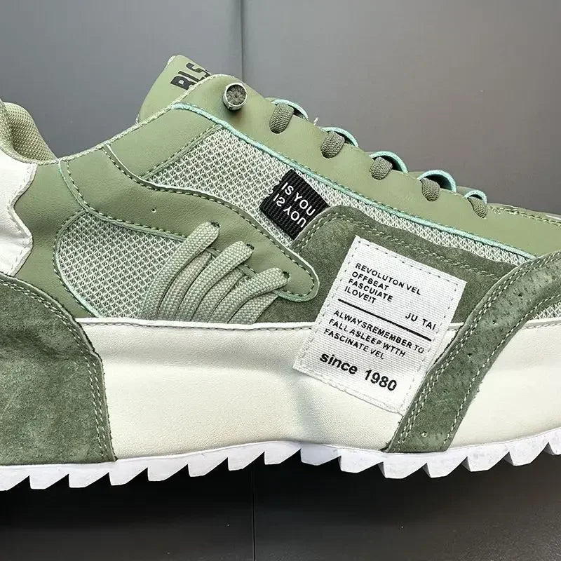 Green and white summer sneaker with visible brand label on a dark background