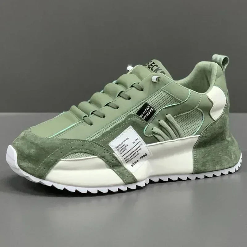 Green summer sneaker with a white sole on a gray background
