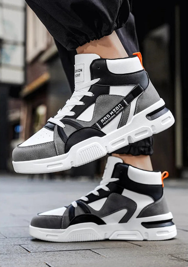 Black and white high-top sneakers worn on a blurred street background