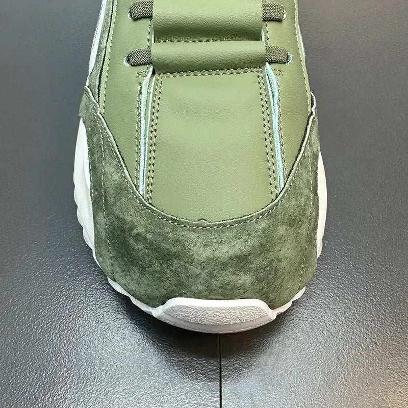 The front of a green summer sneaker with white sole on a dark gray background
