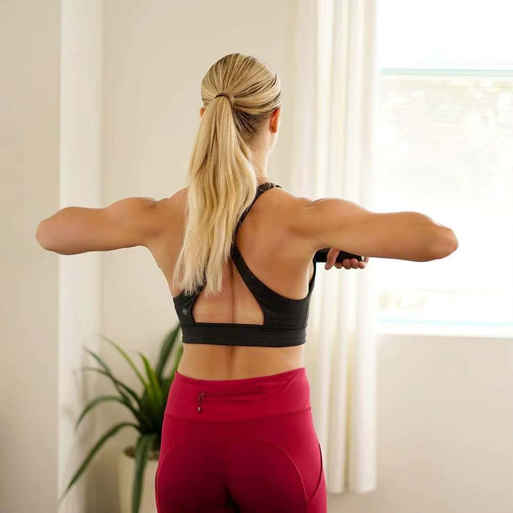 A woman working out with a sunny magnetic rowing machine sold by 100 Spartans