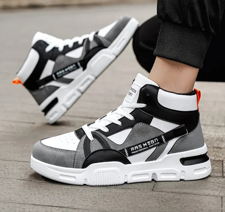 Gray and black sneakers with white accents on a wooden floor.