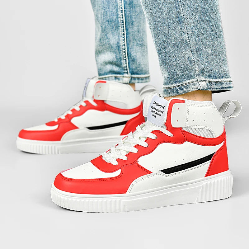 Red and white sneakers with black accents worn with blue jeans on a light gray background