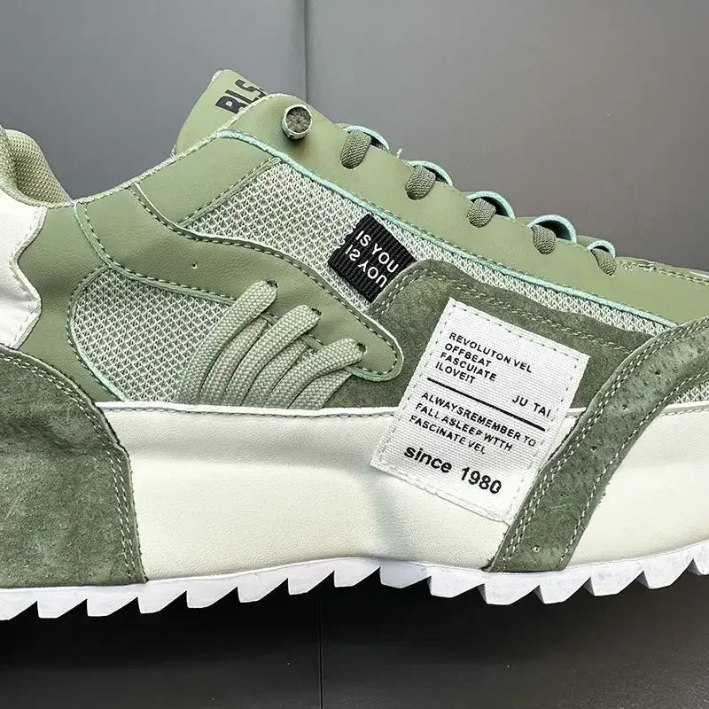 Green and white summer sneaker with visible brand label on a dark background