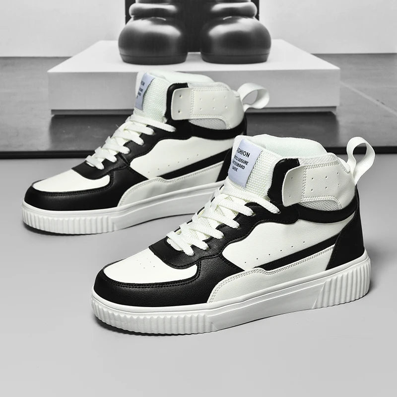 Black and white high-top sneakers on a gray surface with a blurred background