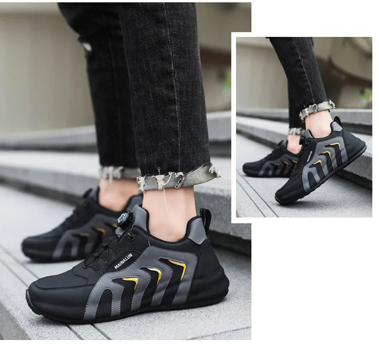 Black and gray sneakers with gold accents worn by a person on steps.