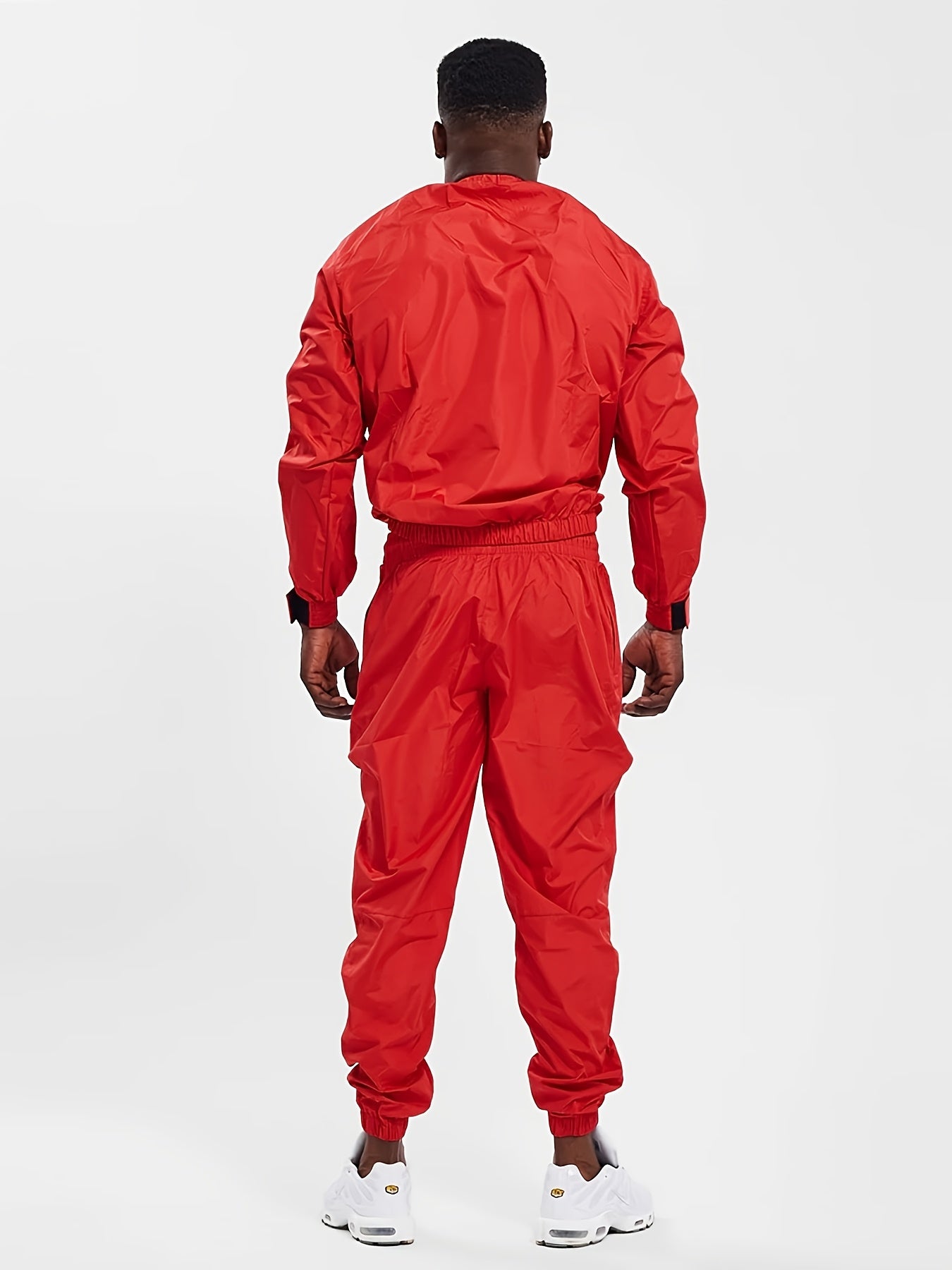 The back view of a person wearing a red sauna suit on a white background