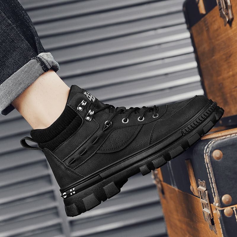 A person wearing a black Martin high top boots
