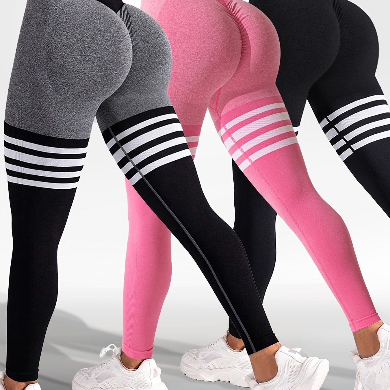 The back view of 3 women wearing a black, pink and grey yoga leggings sold by 100 Spartans