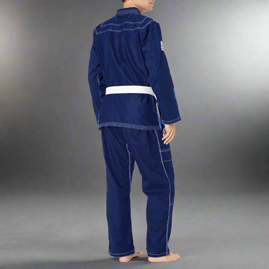 Person wearing a blue martial arts uniform on a gray background