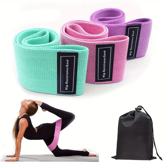 Set of resistance bands in green, pink, and purple with a carrying bag on a white background.