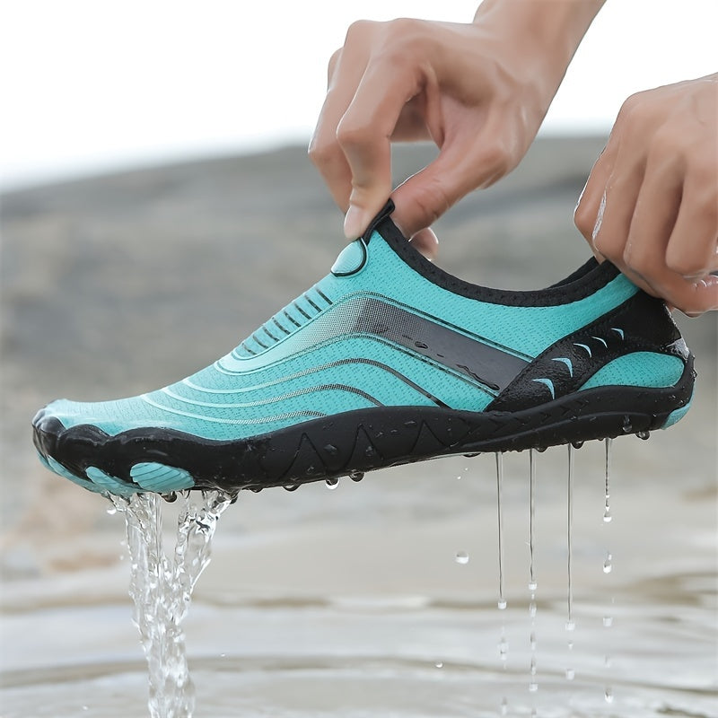 Water hiking shoes with black sole being worn, with water dripping from it, against a blurred natural background.