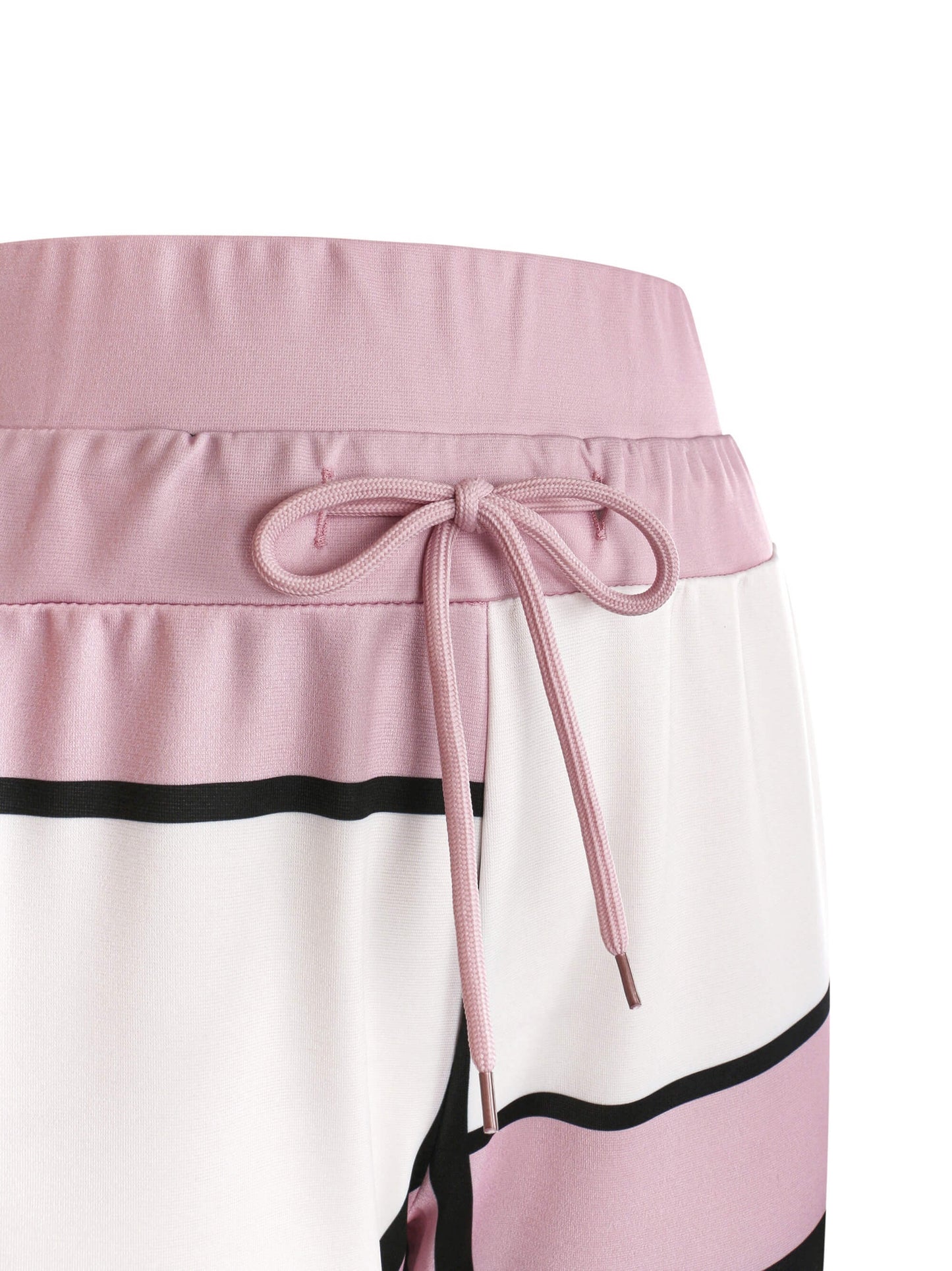 Close-up of a tracksuit pant with pink waistband and black and white pattern on a white background