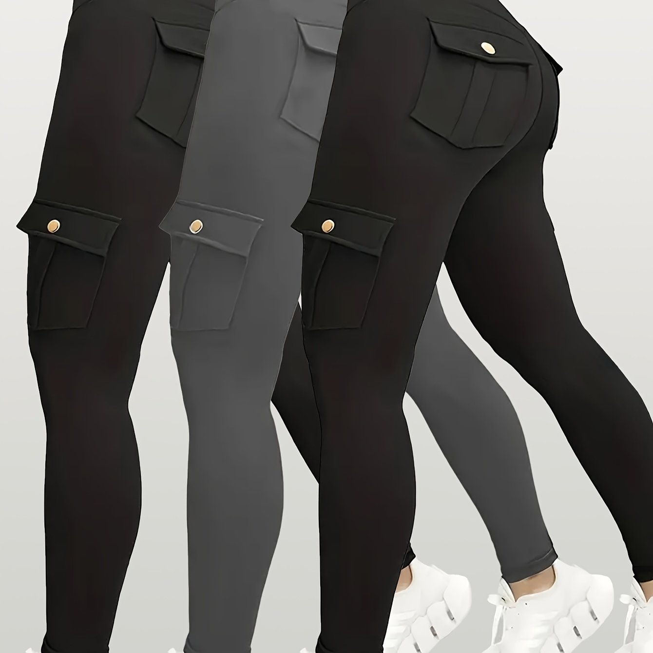 Black and gray yoga leggings with pocket details on a light gray background