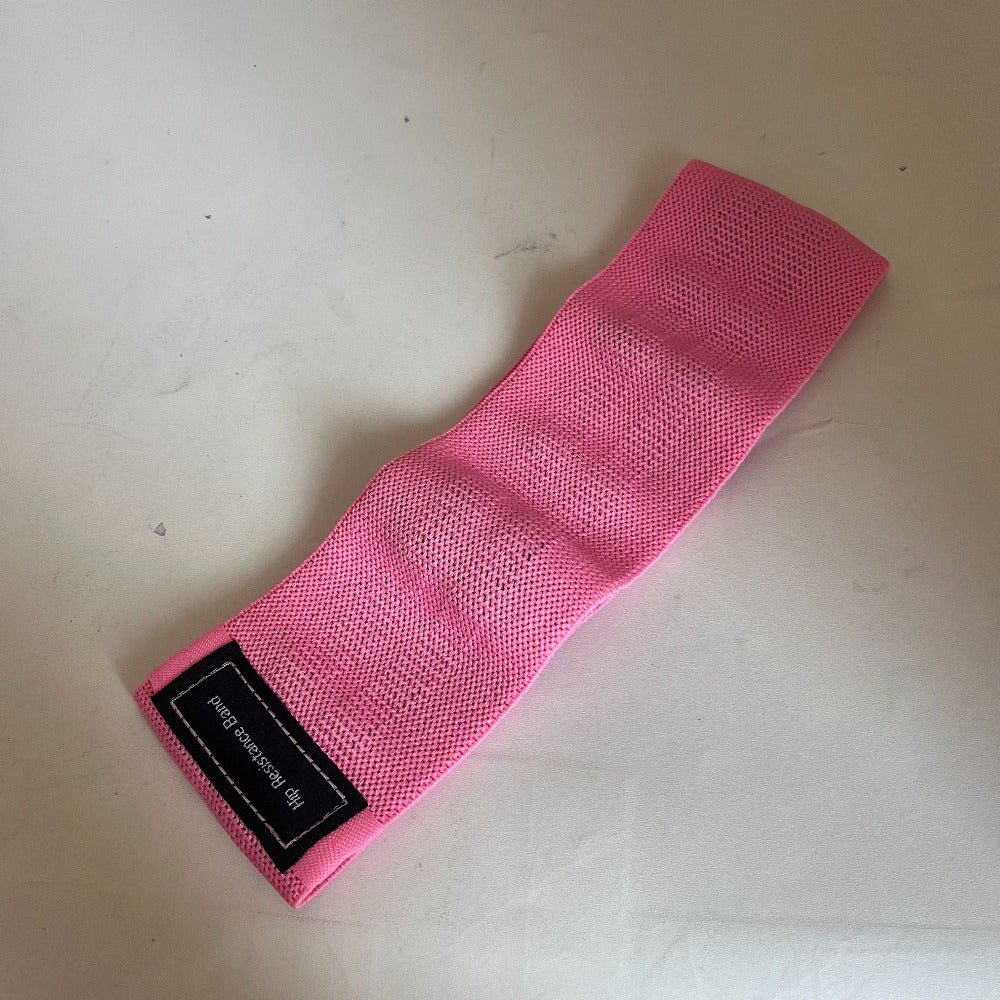 Pink wrist wrap with a label on a beige surface