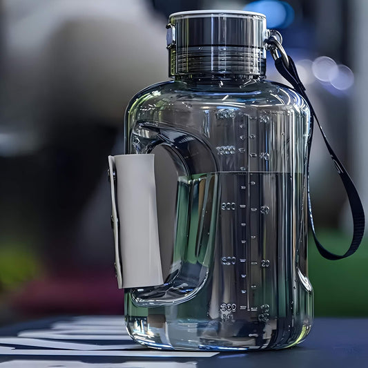Grey portable hydrogen water bottle with measurement markings on a blurred background