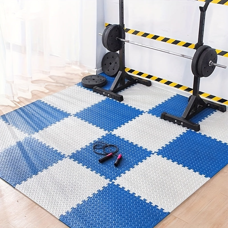Blue and white checkered foam puzzle mats in a gym setting with weightlifting equipment.