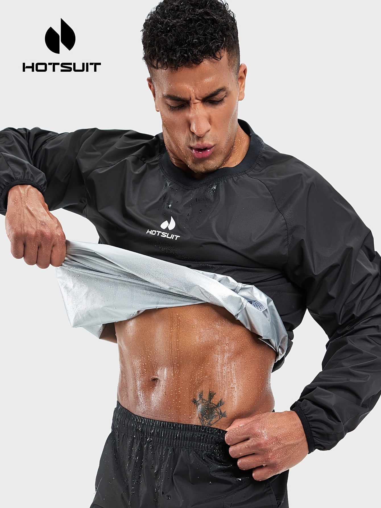 Man wearing a black sauna sweat suit top with a white background