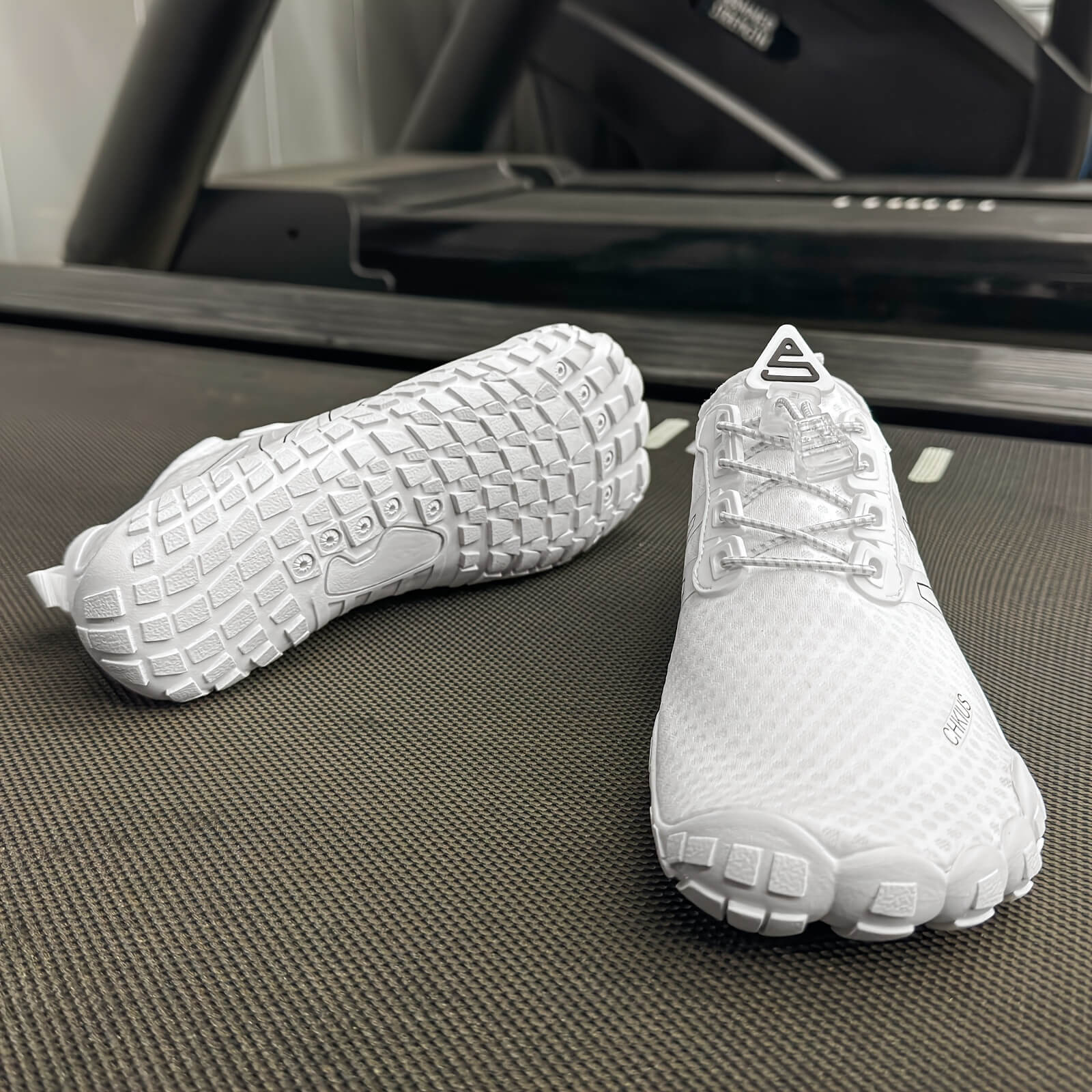 White deadlift shoes on a treadmill